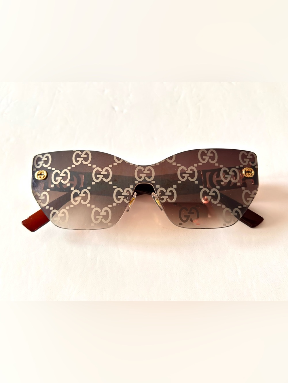 Gucci shield laser monogram sunglasses feature a rimless mask structure GG68024